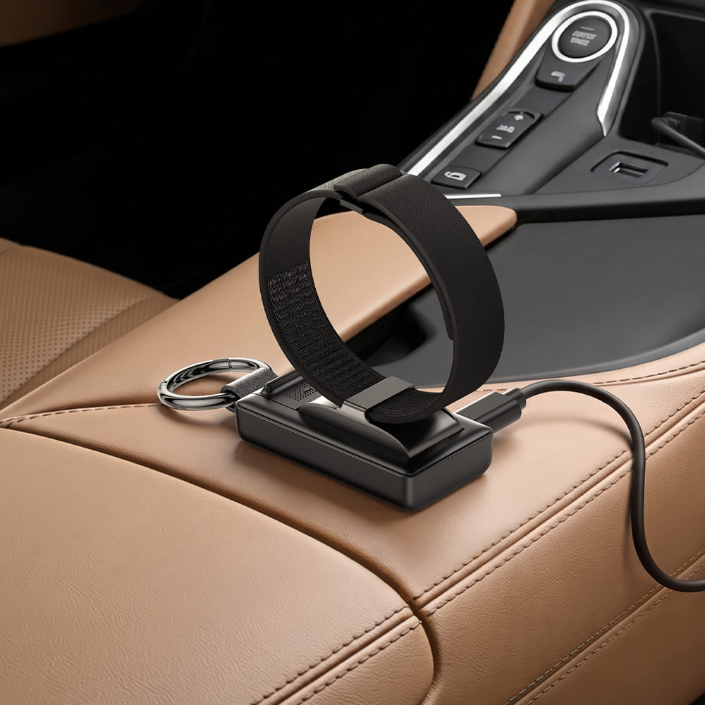 Hume Band 1.0 car charger with keychain on leather center console armrest with SwanScout 513